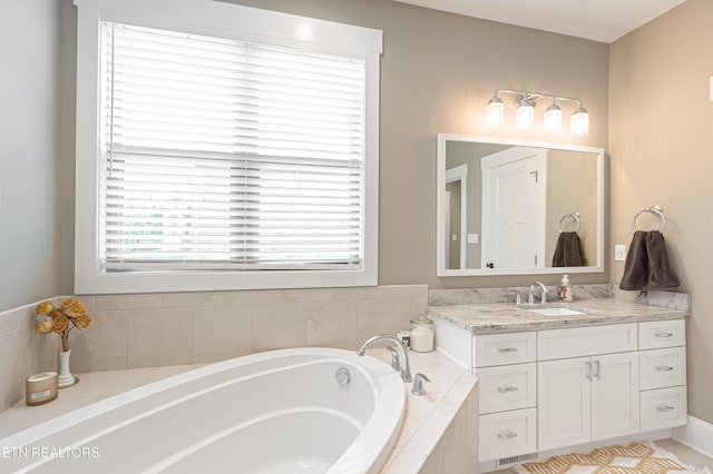 full bathroom with a garden tub, visible vents, and vanity
