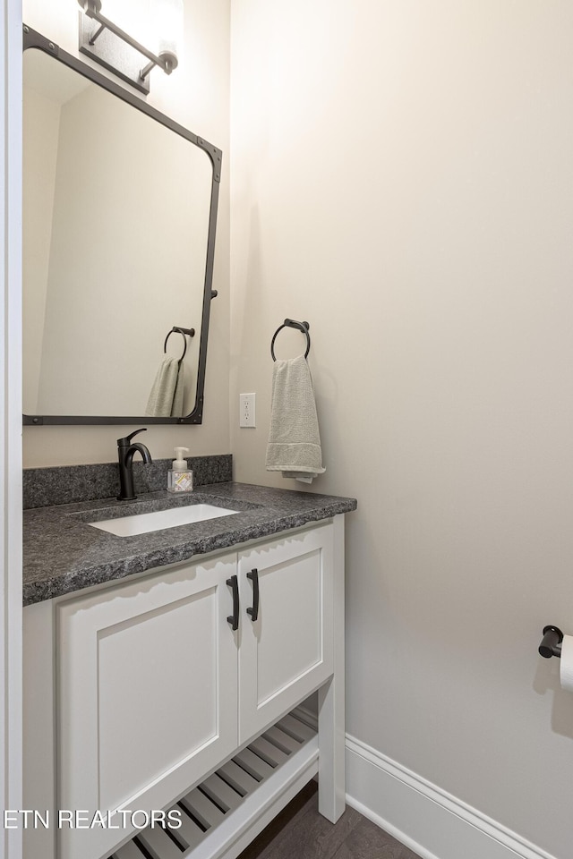 bathroom featuring vanity and baseboards