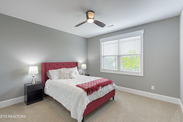 bedroom featuring a ceiling fan, visible vents, carpet floors, and baseboards