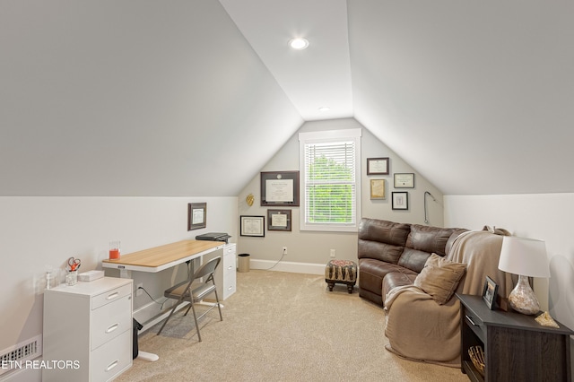 office area with light colored carpet, visible vents, vaulted ceiling, and baseboards