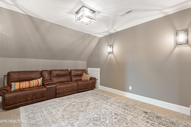 interior space featuring baseboards, visible vents, carpet floors, and vaulted ceiling