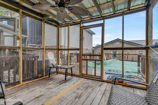 unfurnished sunroom with a ceiling fan