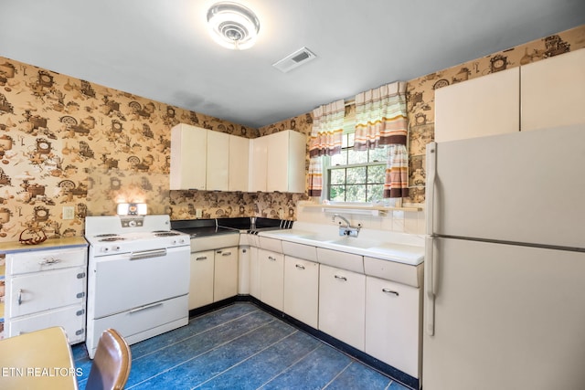 kitchen with a sink, white appliances, wallpapered walls, decorative backsplash, and visible vents