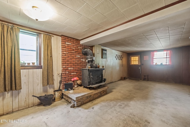 below grade area featuring a wood stove and wood walls