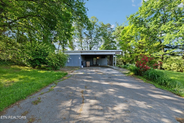 mid-century modern home with a carport and driveway