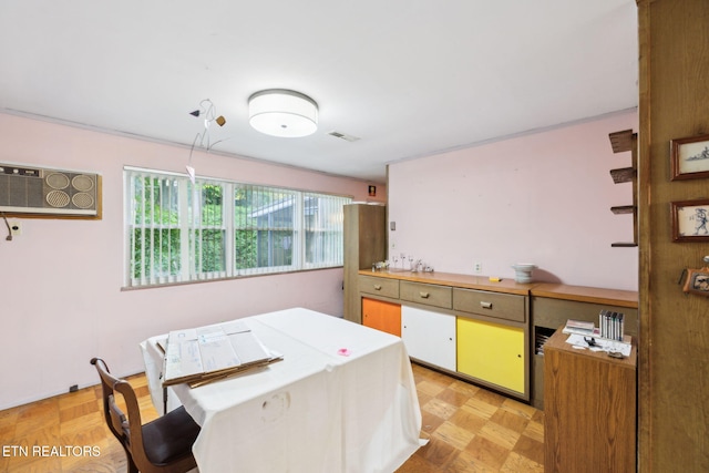 kitchen with visible vents, light countertops, and a wall unit AC