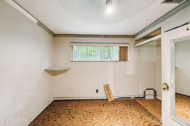 spare room with ornamental molding and wood finished floors