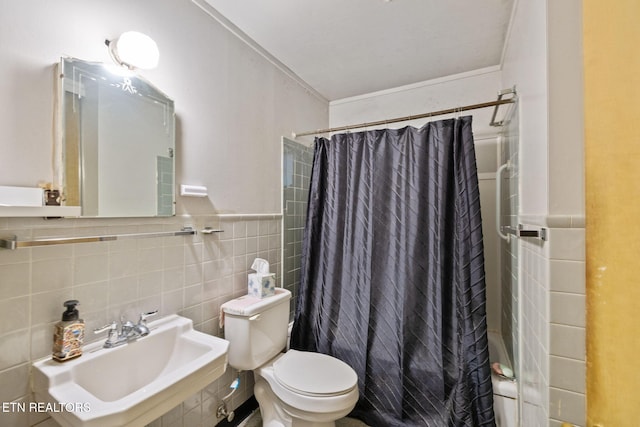 bathroom featuring toilet, tile walls, a sink, and shower / tub combo