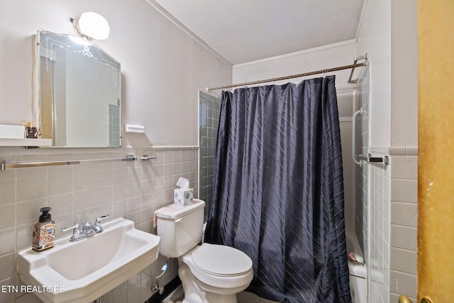 bathroom with crown molding, shower / bath combination with curtain, toilet, tile walls, and a sink
