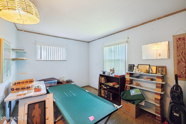 recreation room with crown molding and wood finished floors