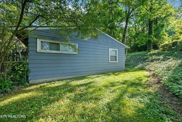 view of side of home featuring a yard
