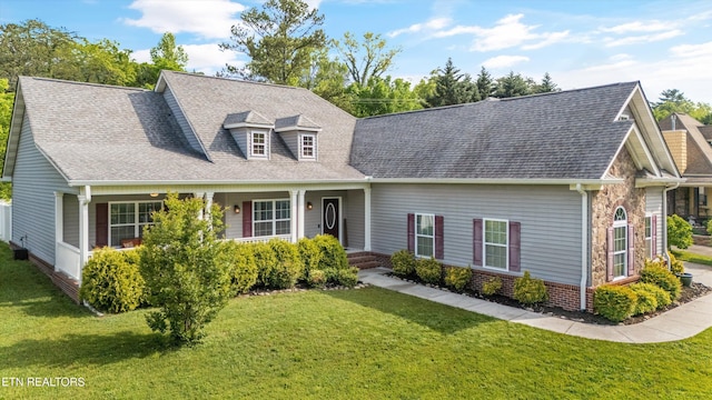 cape cod-style house with a shingled roof and a front yard