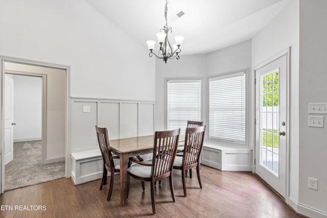 dining space featuring an inviting chandelier, wainscoting, wood finished floors, and visible vents