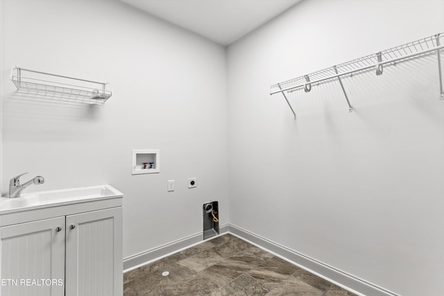 laundry area with washer hookup, electric dryer hookup, cabinet space, a sink, and baseboards