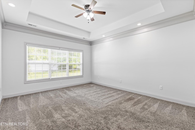 carpeted spare room with recessed lighting, a ceiling fan, baseboards, a tray ceiling, and visible vents