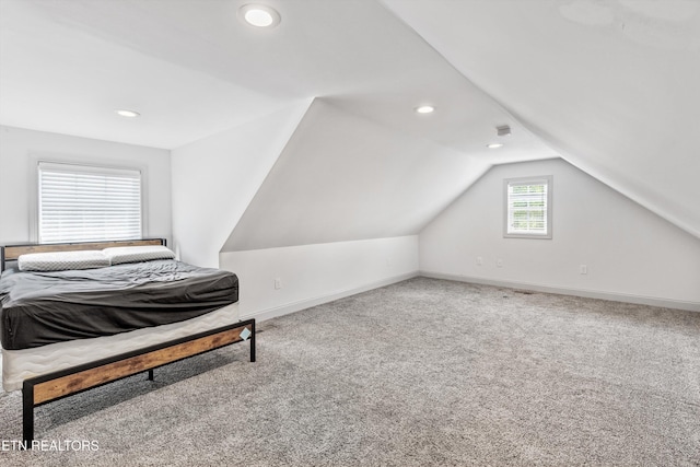 unfurnished bedroom featuring baseboards, carpet, vaulted ceiling, and recessed lighting