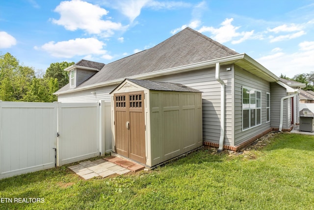 view of shed with fence and a gate