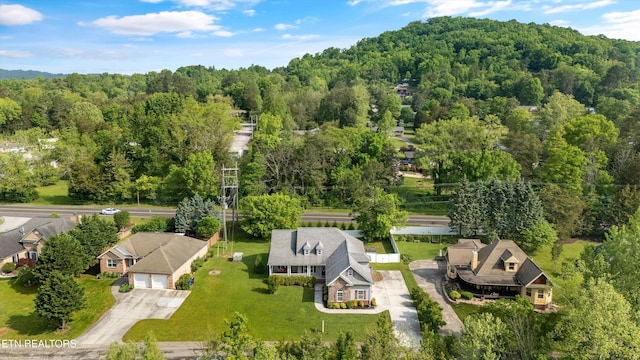 drone / aerial view featuring a forest view