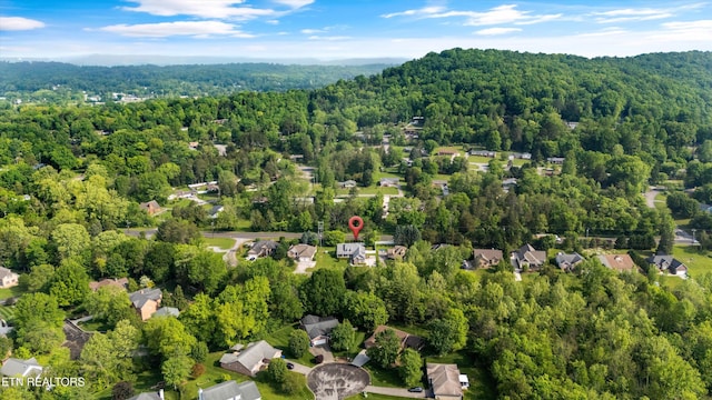 birds eye view of property with a wooded view