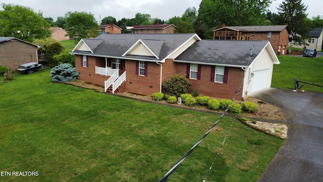 ranch-style house with brick siding, aphalt driveway, a garage, crawl space, and a front lawn