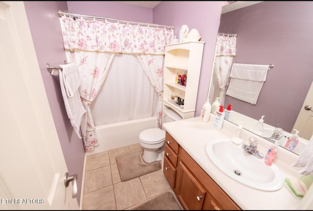 full bath with tile patterned floors, shower / bath combo with shower curtain, toilet, and vanity