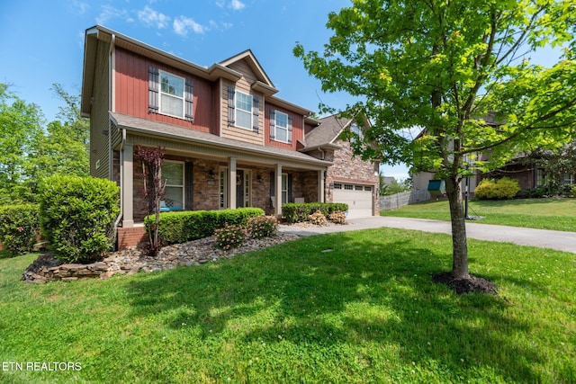 craftsman house with a porch, a garage, a front lawn, concrete driveway, and stone siding