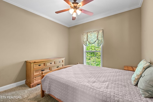 bedroom featuring crown molding, baseboards, ceiling fan, and carpet