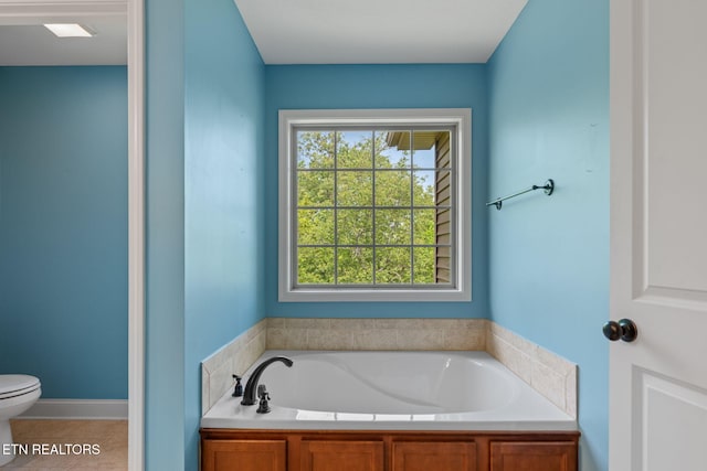 full bath with toilet, tile patterned flooring, and a garden tub