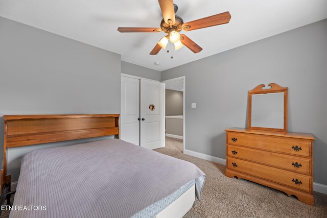 bedroom with baseboards, carpet, ceiling fan, and a closet