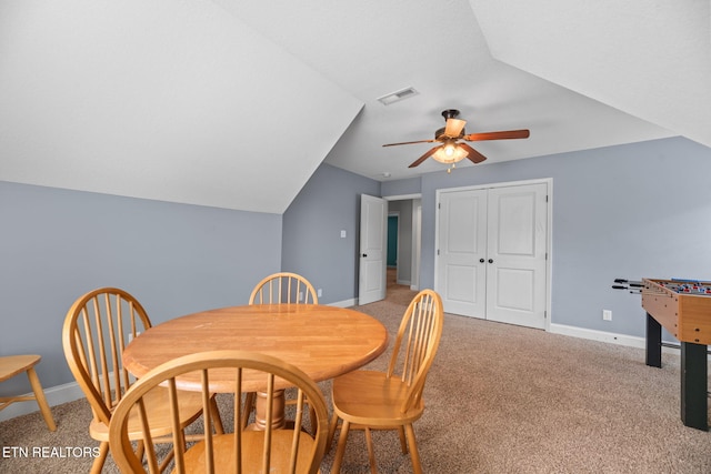 dining room with baseboards, ceiling fan, light colored carpet, and visible vents