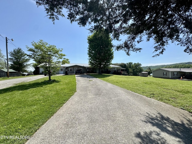 single story home with driveway and a front yard
