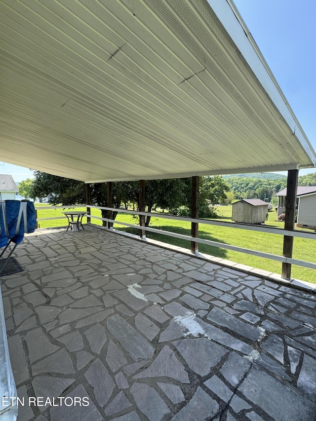 view of patio with a storage unit and an outbuilding