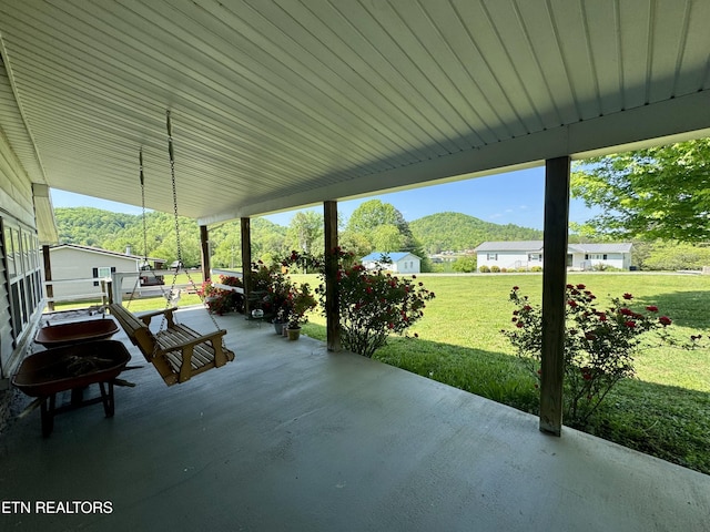 view of patio / terrace featuring a mountain view and covered porch