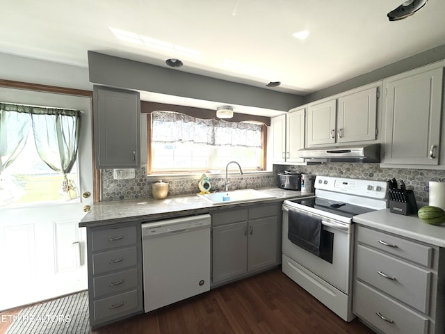 kitchen featuring gray cabinets, under cabinet range hood, and white appliances