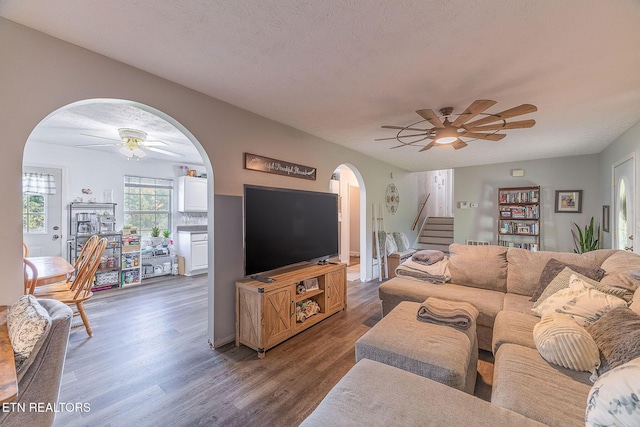 352 St Edward Dr, Dandridge, TN 37725 - living room with dark wood-type flooring, arched walkways, a ceiling fan, and stairway