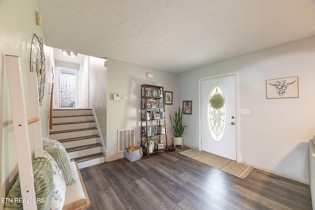 352 St Edward Dr, Dandridge, TN 37725 - foyer featuring stairs, a textured ceiling, visible vents, and wood finished floors