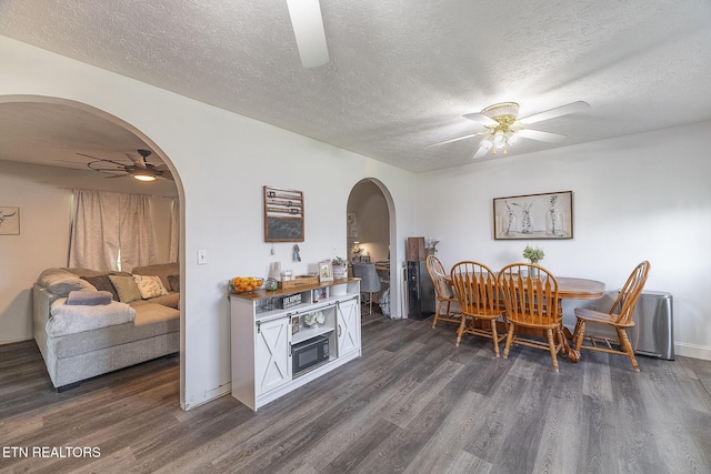 352 St Edward Dr, Dandridge, TN 37725 - dining space with arched walkways, a textured ceiling, ceiling fan, and dark wood-style floors