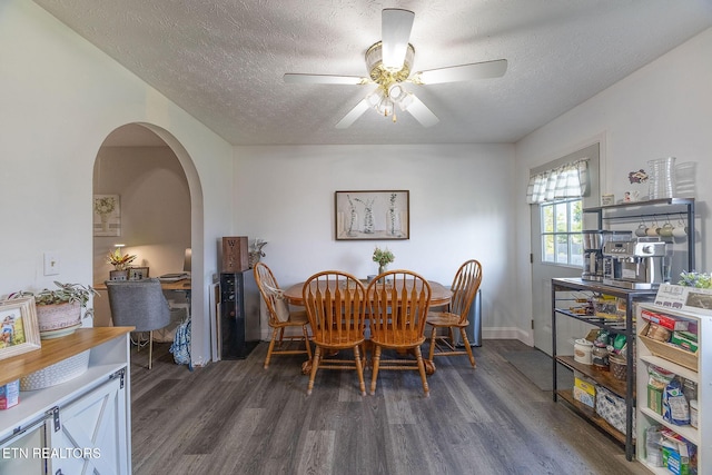 352 St Edward Dr, Dandridge, TN 37725 - dining space with arched walkways, dark wood-style flooring, a textured ceiling, and ceiling fan