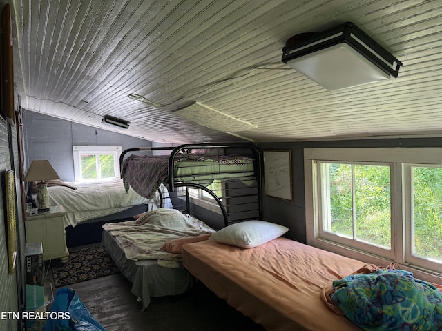 bedroom with wooden ceiling and wood finished floors