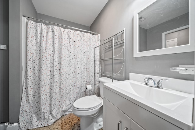bathroom with toilet, a shower with curtain, visible vents, and vanity