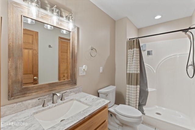 full bathroom with vanity, a shower with shower curtain, and toilet