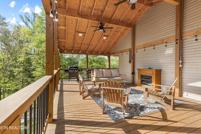 deck with a ceiling fan, a grill, and outdoor lounge area