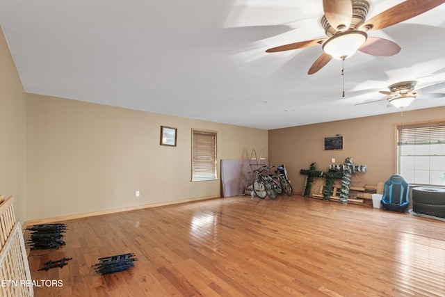 interior space with ceiling fan and wood finished floors