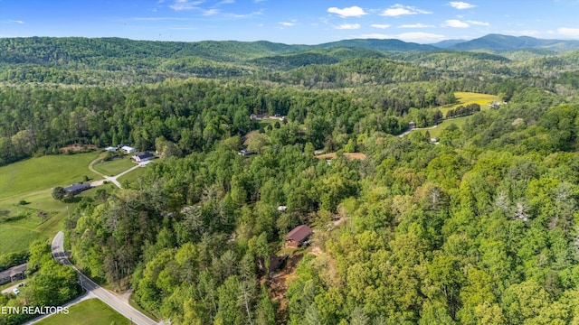 drone / aerial view with a mountain view and a forest view