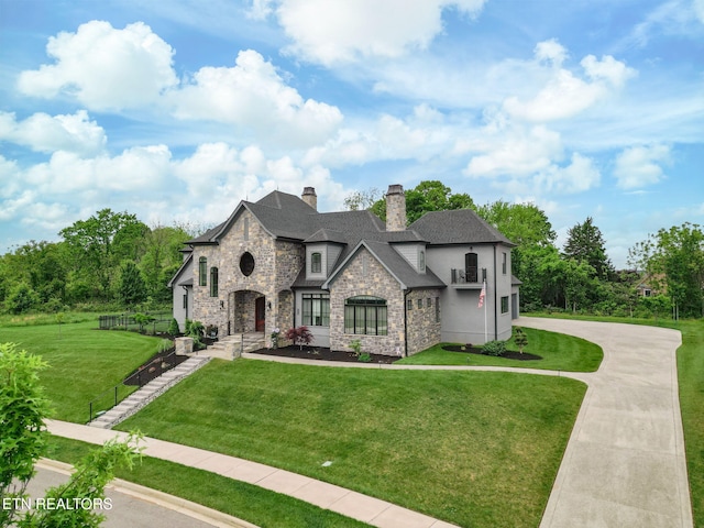 367 Barnsley Rd, Farragut, TN 37934 - french country home featuring a front lawn, stone siding, a chimney, stucco siding, and fence