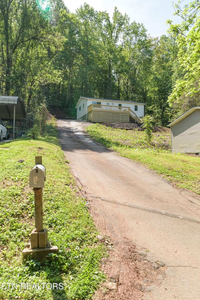 218 Jerry Ln, Knoxville, TN 37920 - view of front of house featuring asphalt driveway and a view of trees