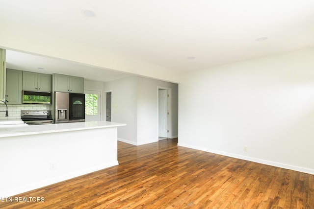 218 Jerry Ln, Knoxville, TN 37920 - unfurnished living room with dark wood-type flooring and baseboards