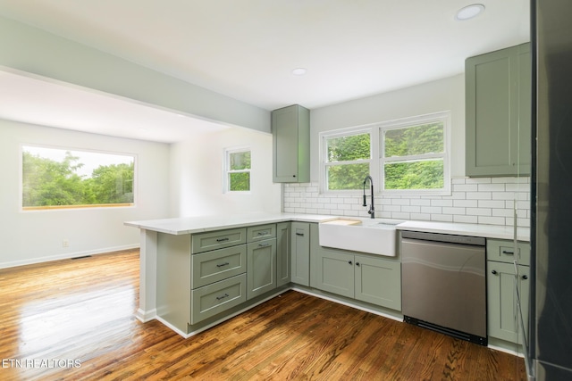 218 Jerry Ln, Knoxville, TN 37920 - kitchen with stainless steel dishwasher, green cabinetry, a peninsula, a sink, and light countertops