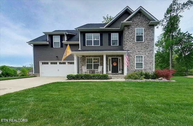 107 Mistletoeberry Rd, Oak Ridge, TN 37830 - craftsman-style house featuring a porch, concrete driveway, stone siding, and a front lawn