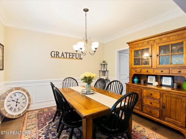 107 Mistletoeberry Rd, Oak Ridge, TN 37830 - dining space with an inviting chandelier, a decorative wall, ornamental molding, a wainscoted wall, and dark wood-style flooring